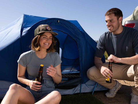 SURF REV TENT COUPLE TOAST BEERS